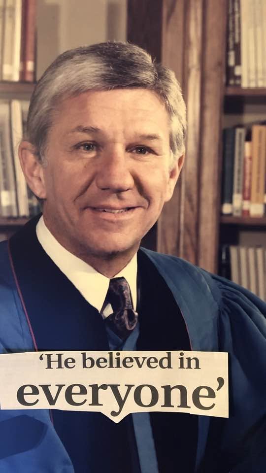 Rev. Otis E. Young in his pulpit robe, with the newspaper headline “He believed in everyone”